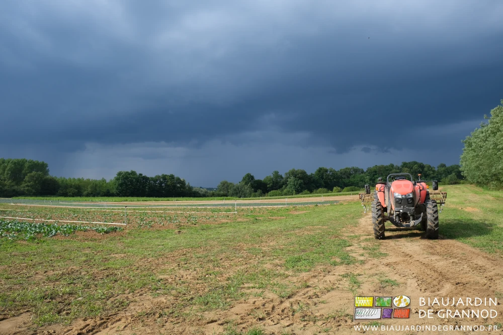 photo d'un grand ciel noir sur le jardin, tracteur de retour du travail